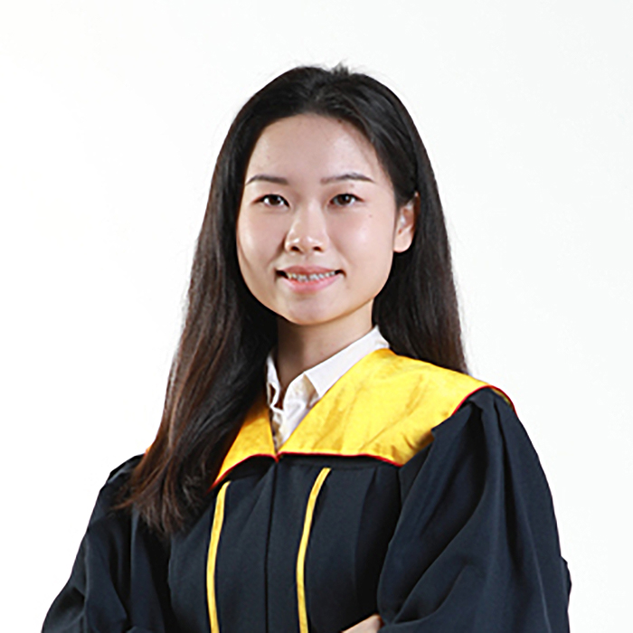 girl in graduating gown smiling