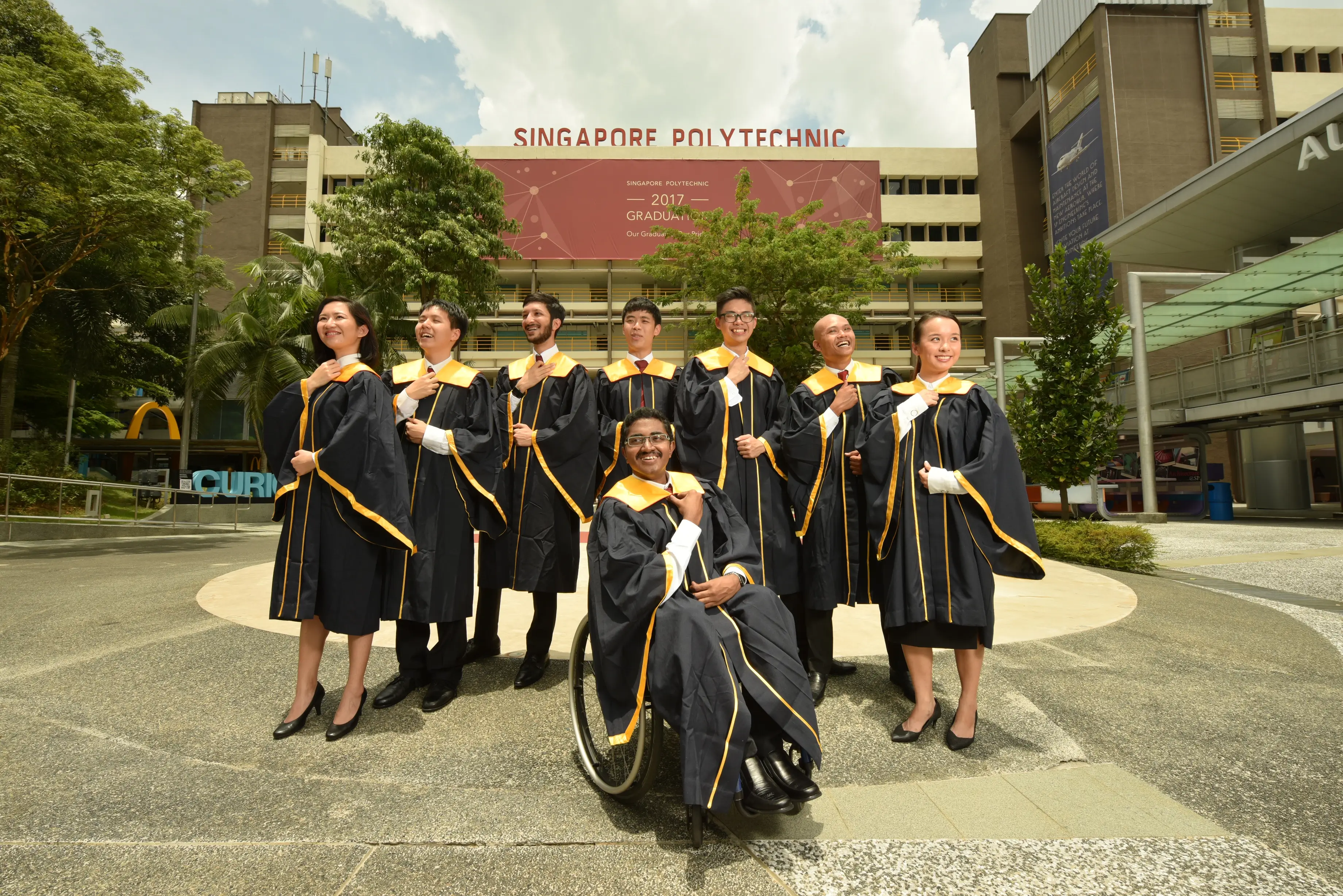 Group of proud SP graduates posing at SP plaza.