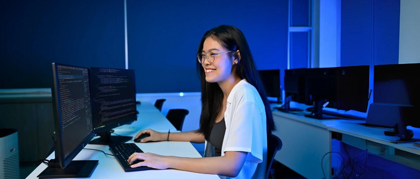 SOC-DCITP Student Looking at Astrobot on Two Monitors