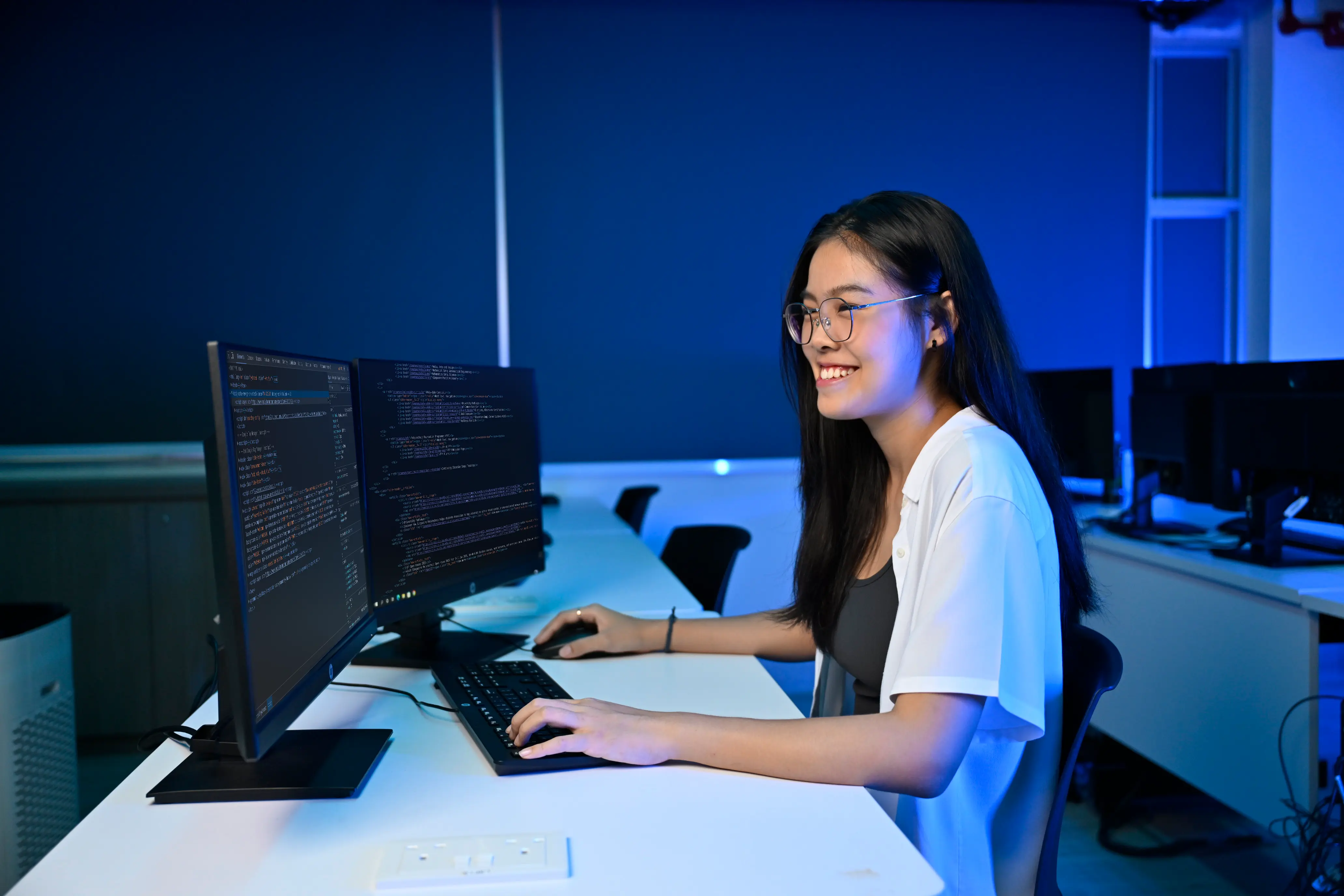 SOC-DCITP-Student-Looking-at-Astrobot-on-Two-Monitors-v01